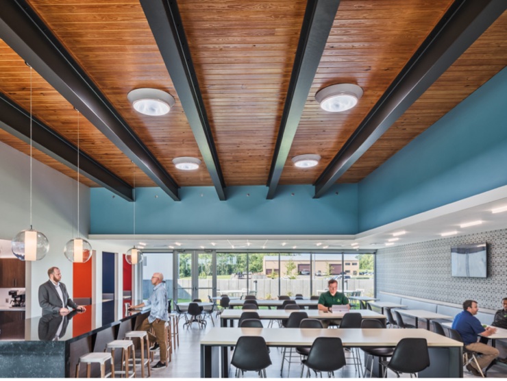 Daylit commercial interior with Solatube diffusers in the ceiling above open workspace and meeting tables