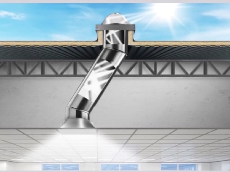 Cutaway of a Solatube SolaMaster system delivering daylight through a reflective tube to a diffuser in a suspended office ceiling